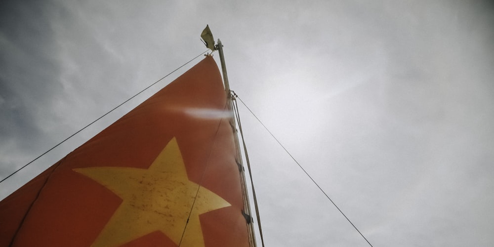 worm's eyeview photo of red and orange sail