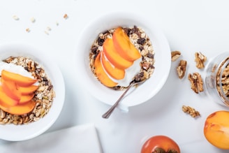bowl of cereal with sliced fruits and spoon