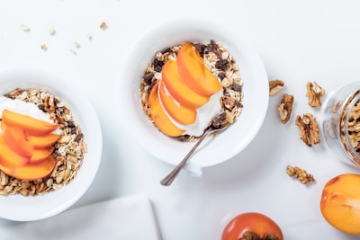 bowl of cereal with sliced fruits and spoon