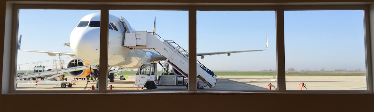 white truck beside white airplane