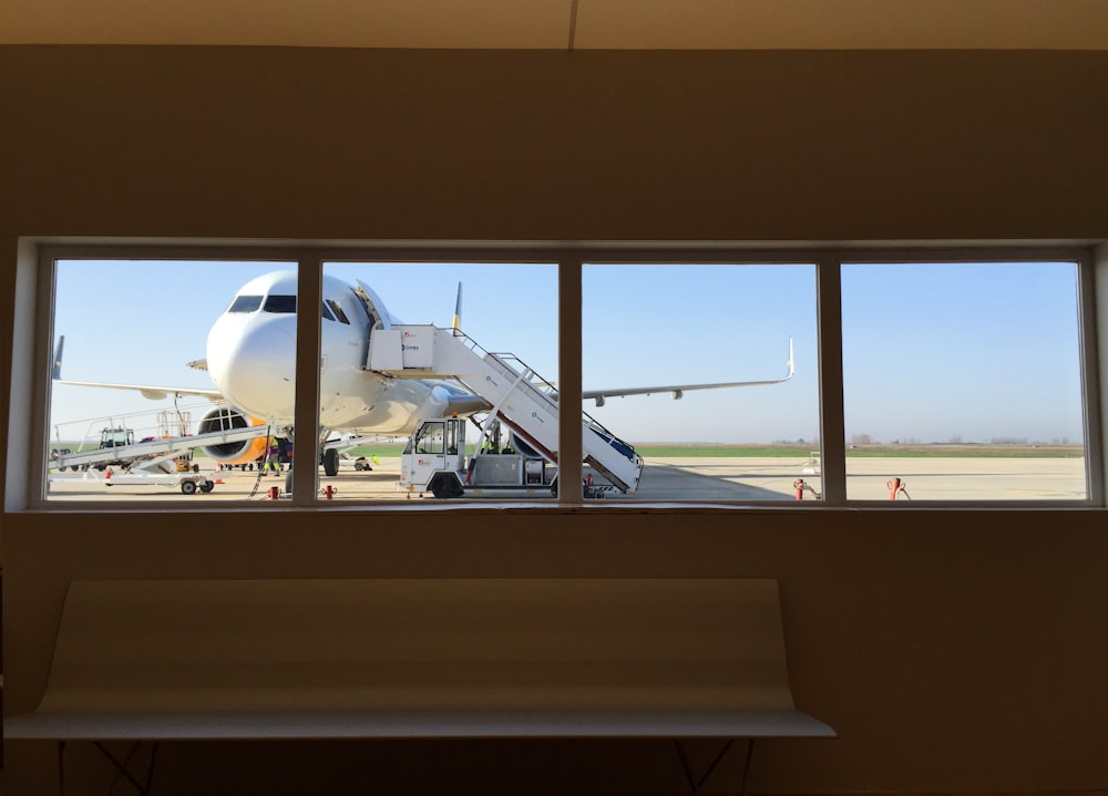 white truck beside white airplane