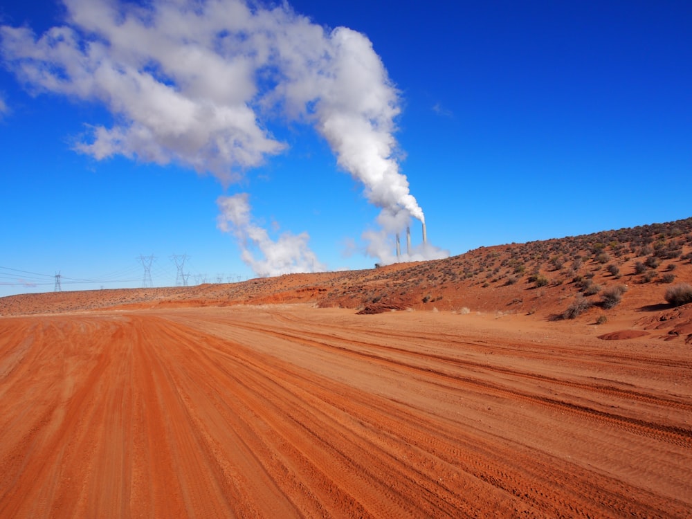 landscape photography of roads and factory smoke