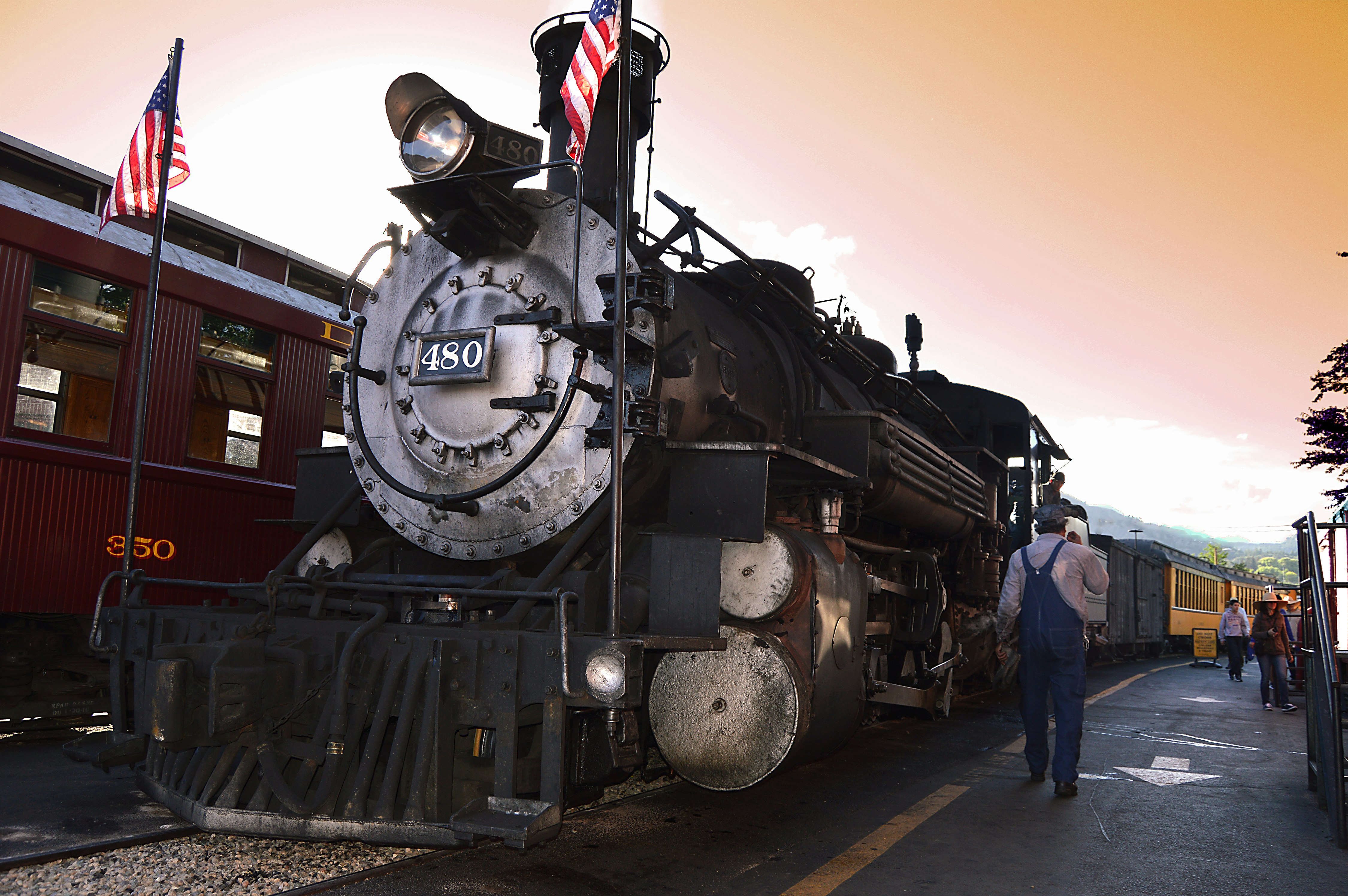 man walking beside locomotive train