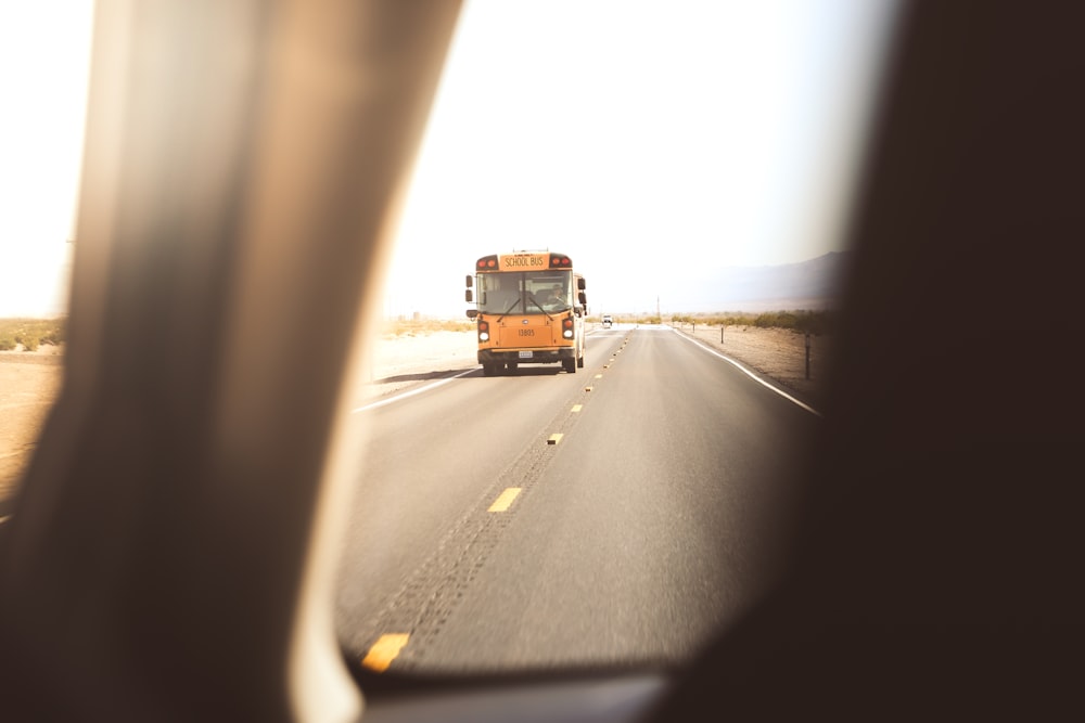 yellow class a motorhome on roadway