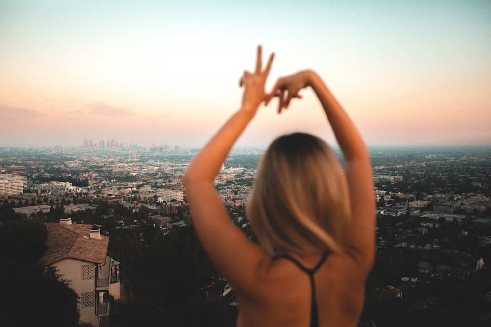 a woman standing in front of a view of a city