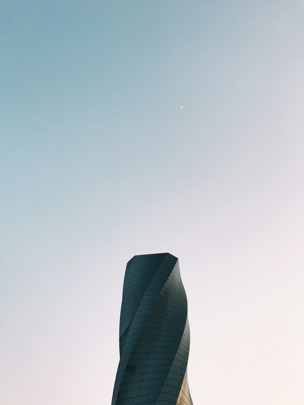 worm's eye view photography of gray tower under clear sky