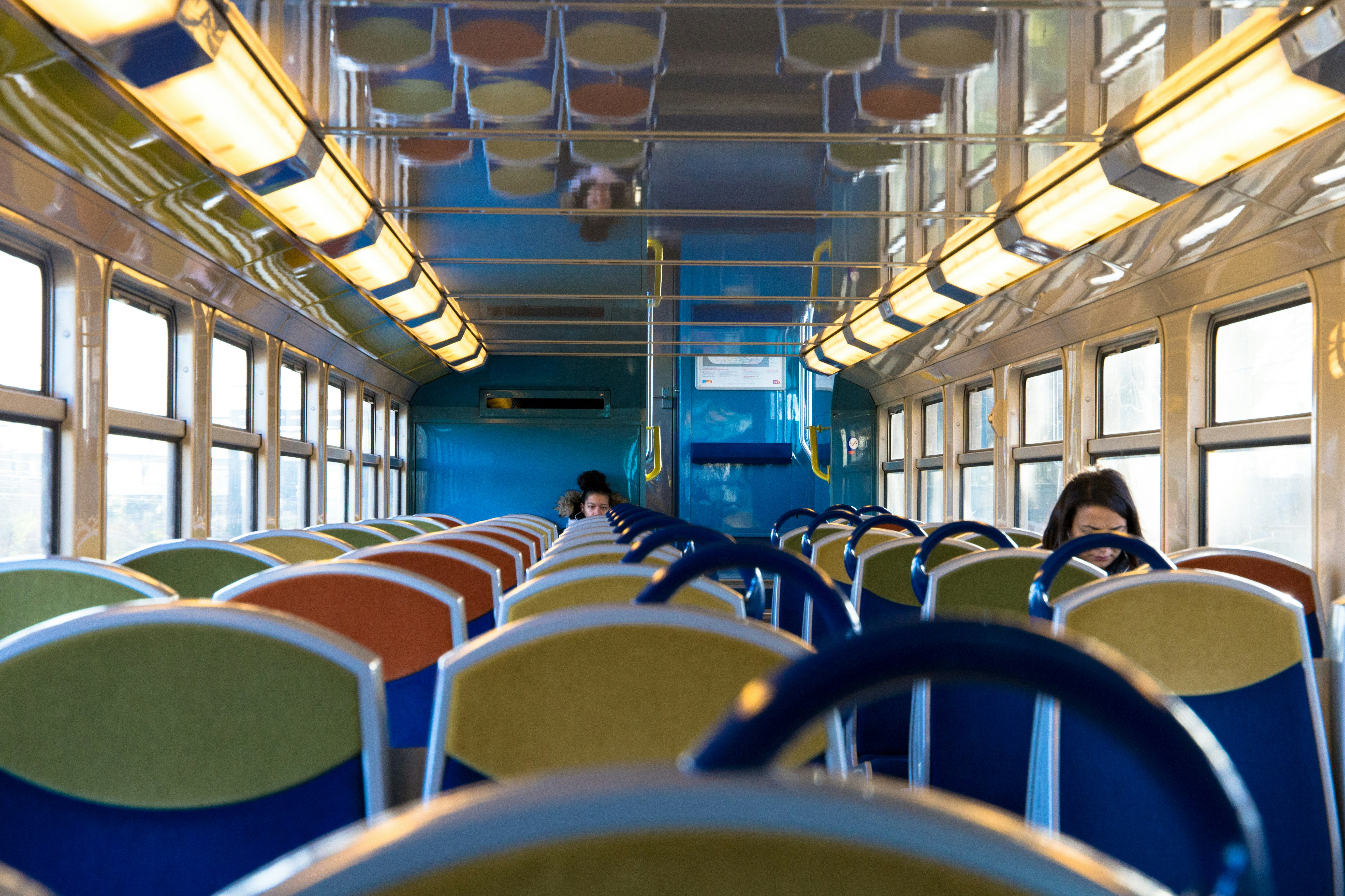 people sitting inside public vehicle, - Part of a 30 days streak of Unsplash uploads -</p><p>Another oldie from 2015 when I took a couple of days to go celebrate NYE at one of my best friends’. As we were taking the suburbs train from Orly Airport to Paris, I took this quick shot of this almost empty wagon.</p><p>The patterns and colors caught my eyes and the yellow lamps made for a moody shot.</p><p>Jp Valery is one of the best photographers in Montréal, QC. He’s a self-taught photographer passionate by his craft. He’s available for hire - no projects are too big or too small - and can be contacted at contact@jpvalery.photo.