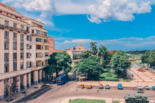 blue bus near trees and building during daytime in Museum of the Revolution Cuba