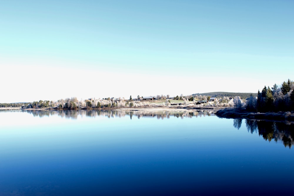 landscape photography of village surrounded with body of water