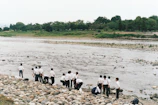 A group planting native trees along a riverbank in Enon Valley.