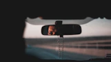 photo of black framed vehicle rear-view mirror