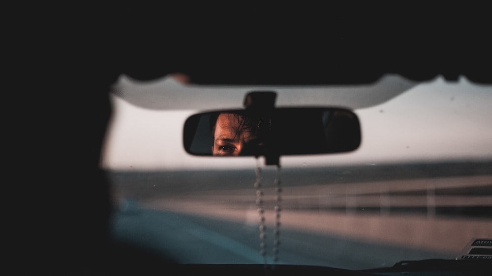 photo of black framed vehicle rear-view mirror