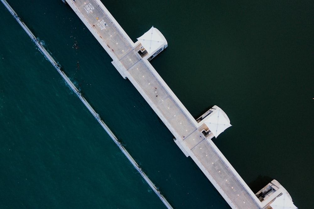 aerial photo of white concrete structure near body of water