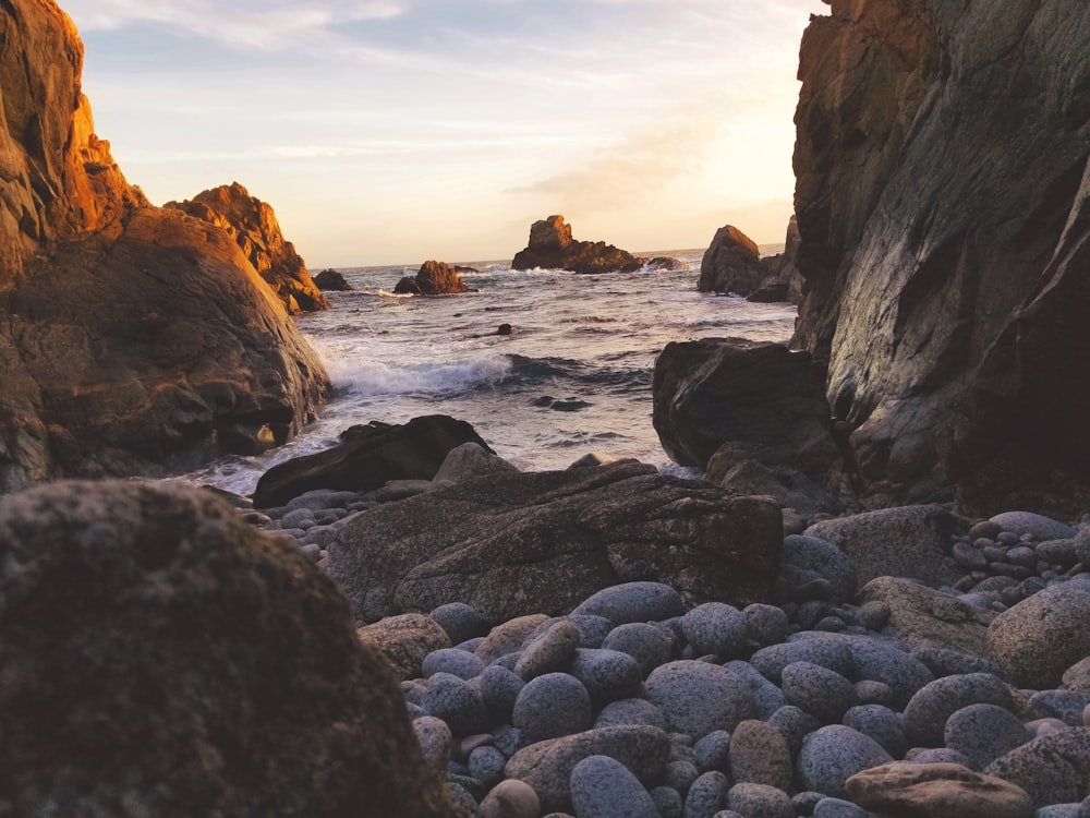 landscape photography of rock formations and body of water