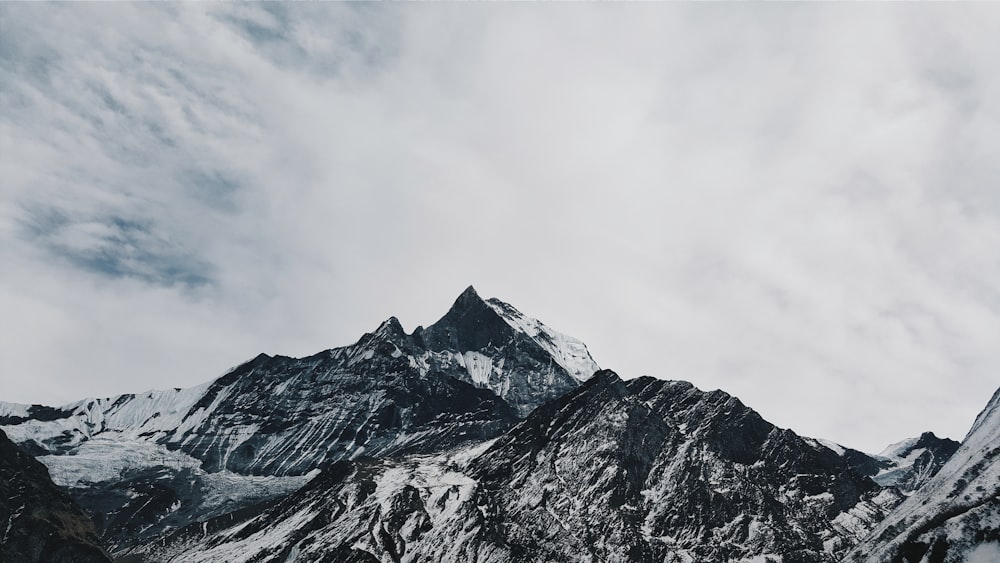 snow cover mountain during white cloudy sky