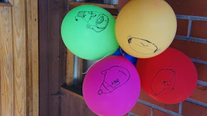 The gang playing with balloons in front of their bright, cozy clubhouse.