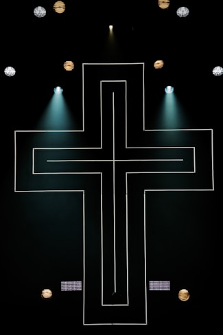string lights cross on dark area with spot lights
