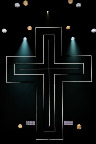 string lights cross on dark area with spot lights