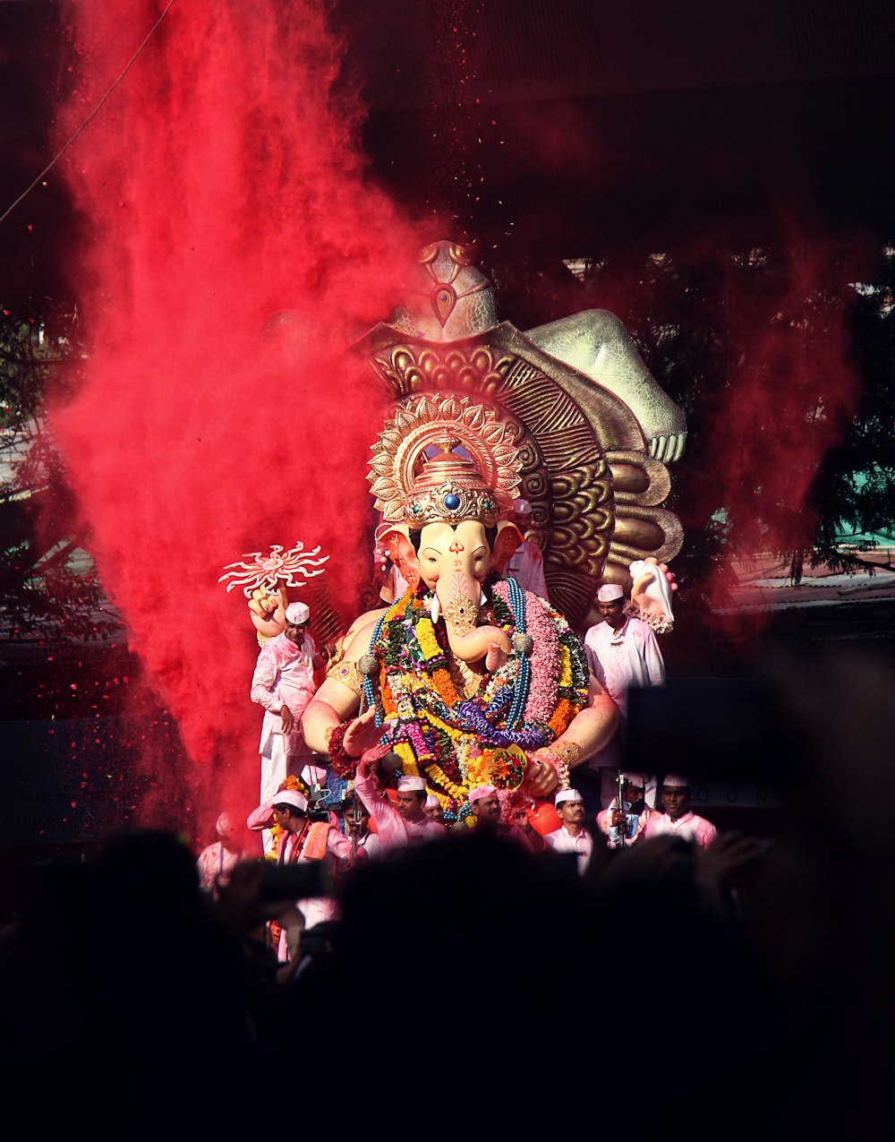 Ganesha statue surrounded by people