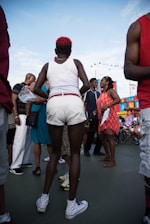 A diverse group of community members gathered outdoors, engaged in a lively discussion under a bright Kansas sky.