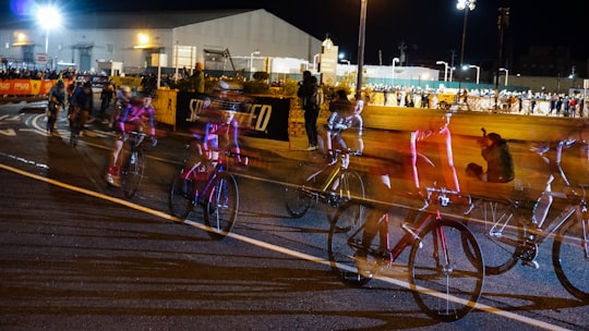 time lapse photography of a cyclists during night race in Red Hook United States