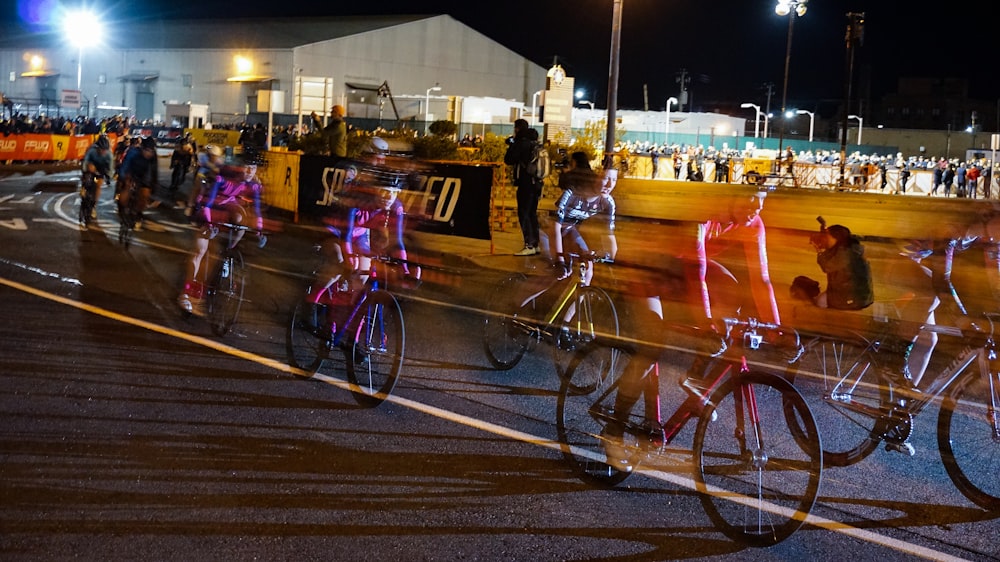 time lapse photography of a cyclists during night race