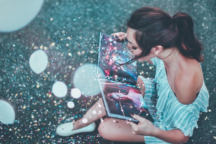 Girl reads a magical photo book with glitter