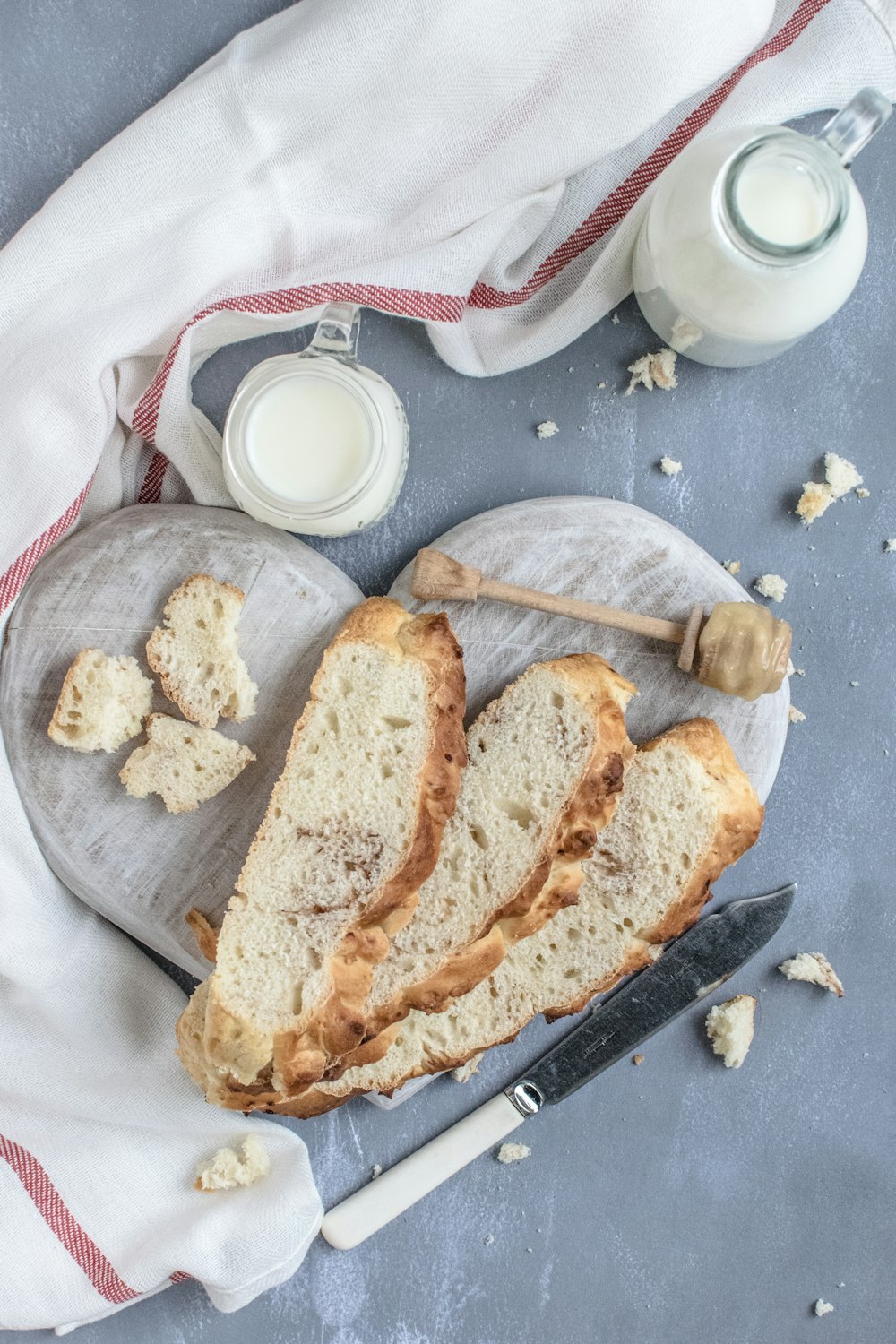 sliced breads on wooden heart chopping board