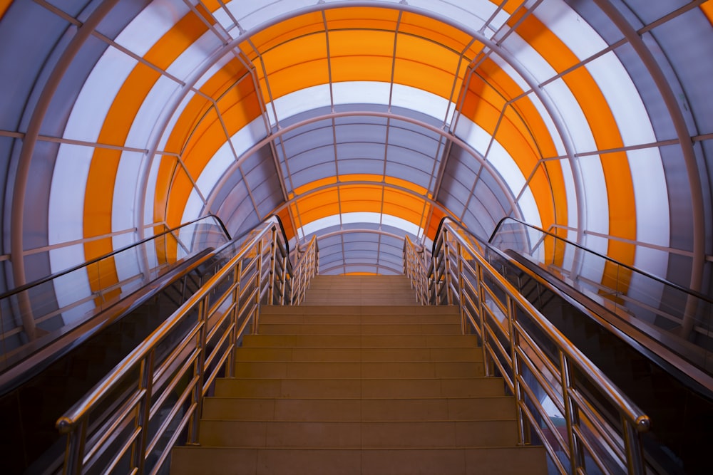brown staircases with chrome handrails in gray and orange dome