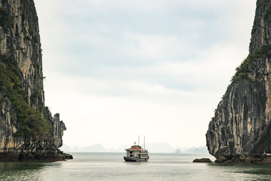 white watercraft on body of water in Ha Long Bay Vietnam