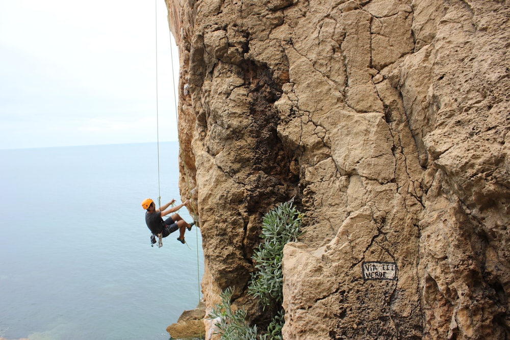 person climbing on hill