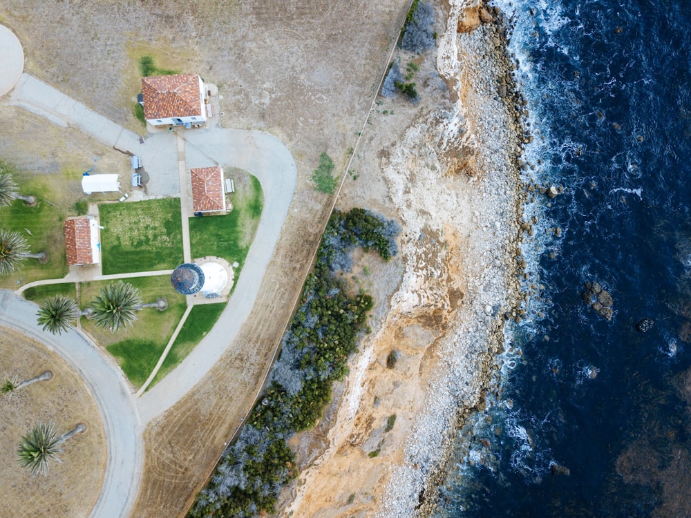 bird's-eye view photography of lighthouse nearby sea