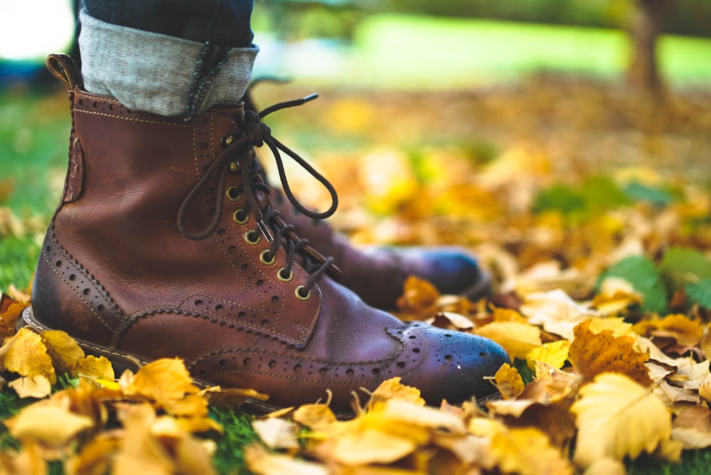close up photo of person wearing brown leather boots