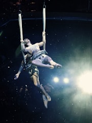 Aerial artist performing a breathtaking mid-air routine with flowing fabric.