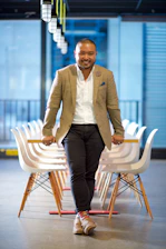 Portrait of the CEO in a sleek office setting with a modern blue and black color scheme background.