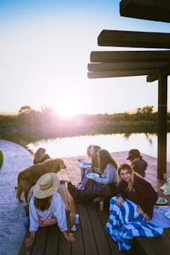 Yacht club members enjoying a barbecue by the lakeside at sunset.