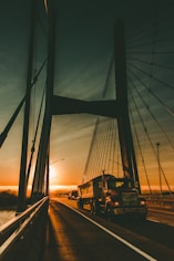 brown Maek freight truck on bridge during dawn