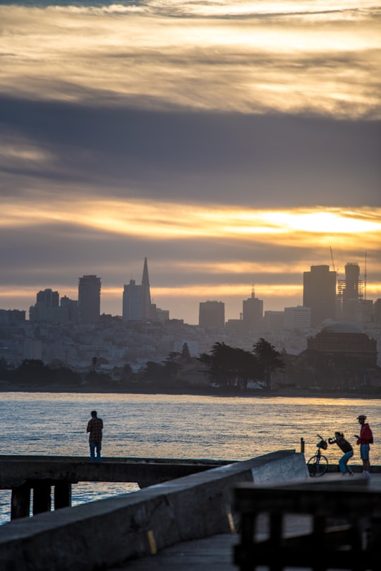 silhouette of people walking on boardwalk during golden hour in Crissy Field United States