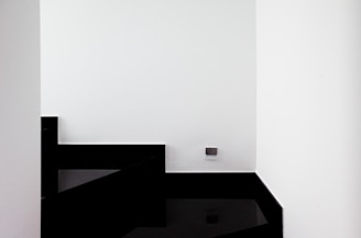 Modern minimalist home interior with black, white, and gold accents.