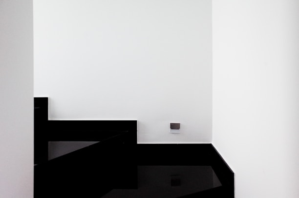 Modern minimalist home interior with black, white, and gold accents.