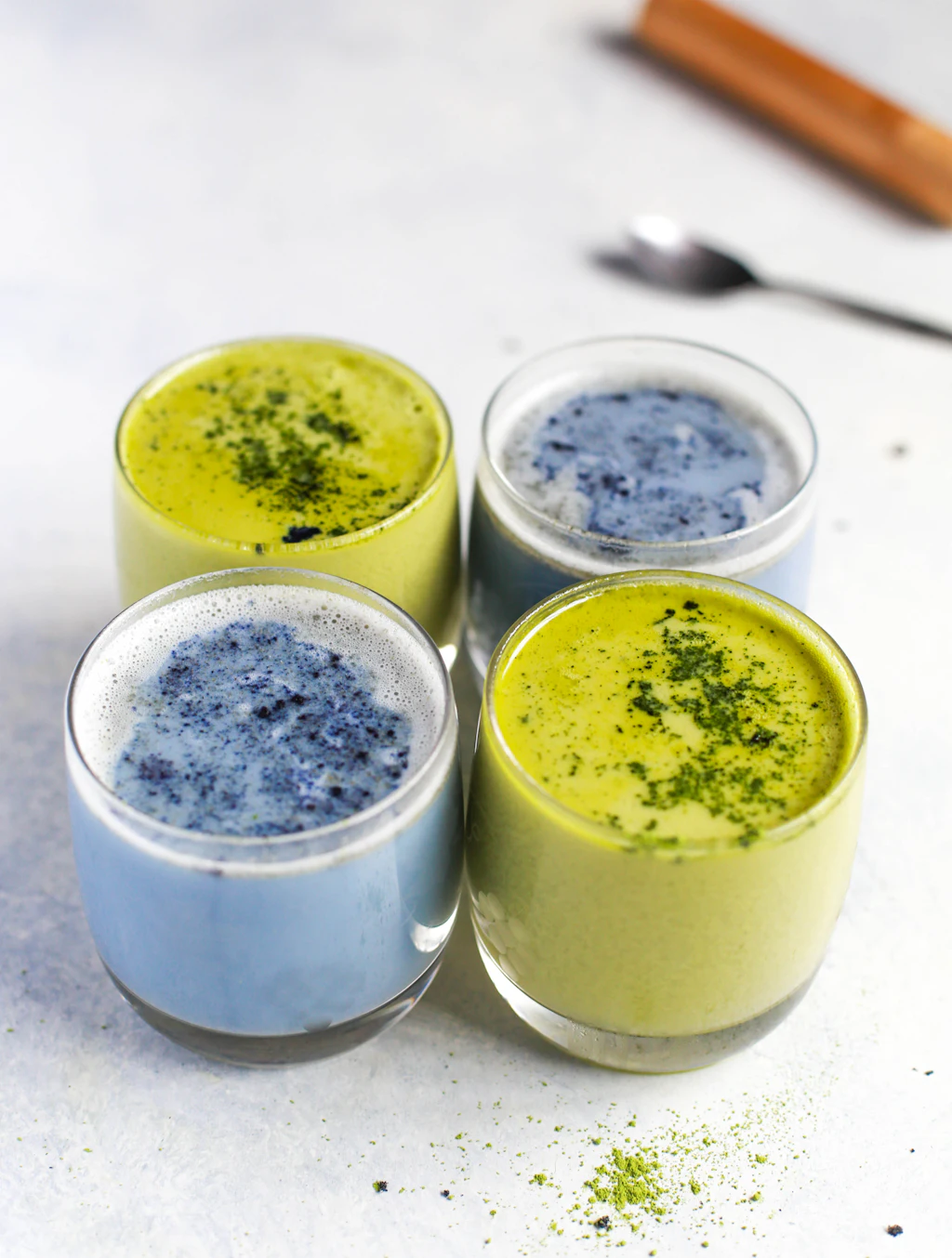 Green and blue latte-style drinks in glasses; recipes not specified