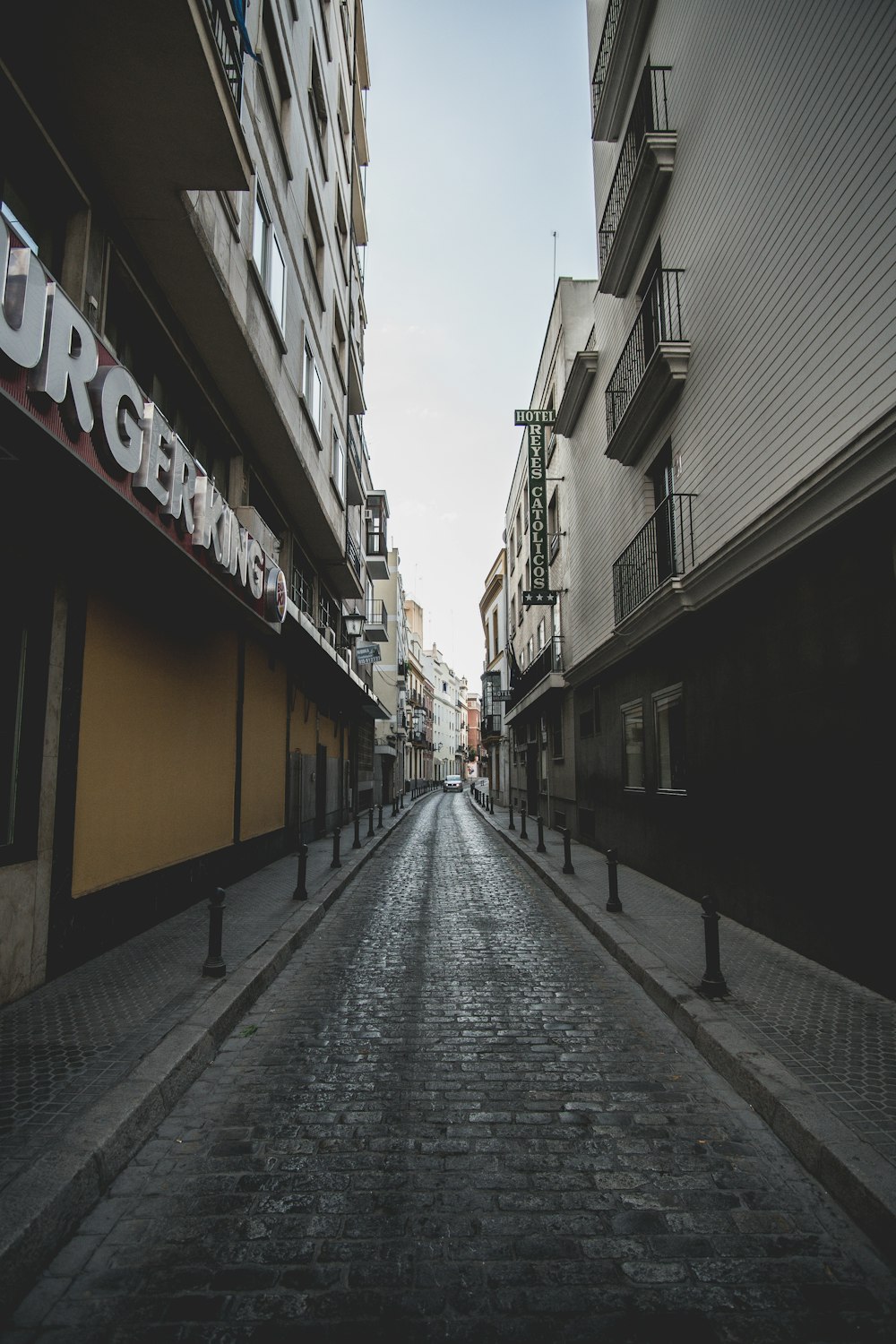 empty street between buildings during daytime