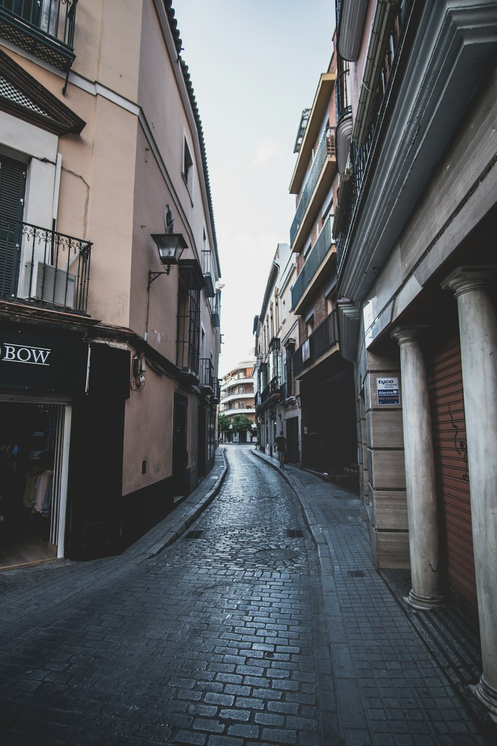 empty street in between of buildings during daytime