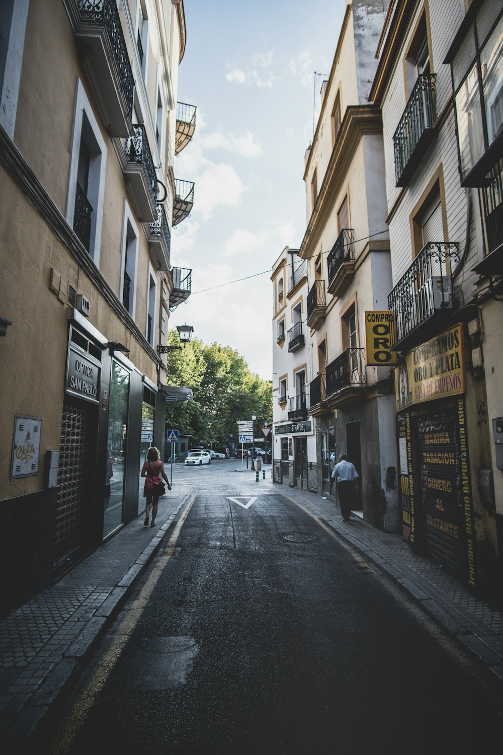 people walking on street between buildings during daytime