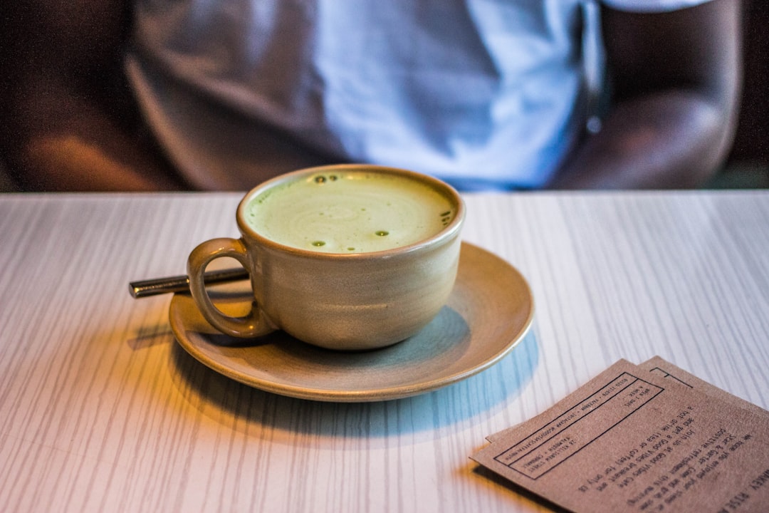 brown ceramic cup with saucer