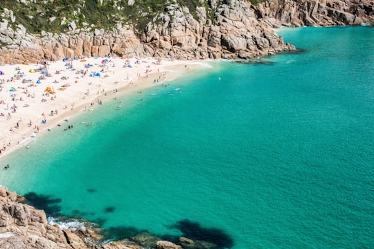 seashore with group of people during daytime in Penwith Heritage Coast United Kingdom