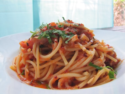 Close-up of a delicious plate of homemade pasta with tomato sauce and basil garnish