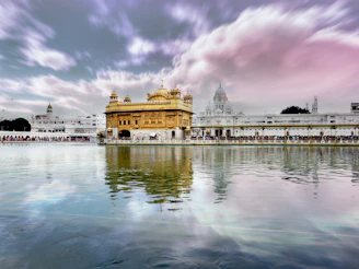 A serene sunrise view of the Golden Temple bathed in soft morning light.