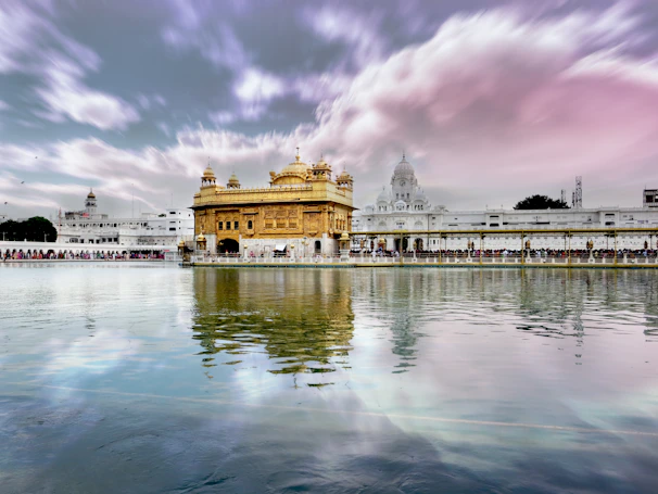 A serene sunrise view of the Golden Temple bathed in soft morning light.