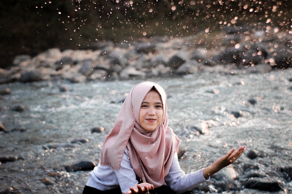 woman playing with water on river